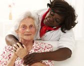 caregiver hugging senior woman