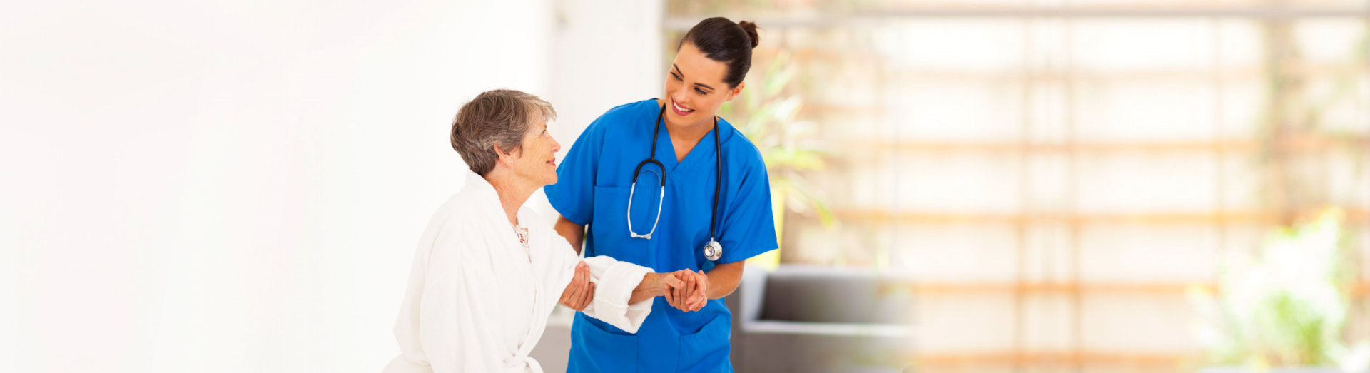 nurse helping senior to walk