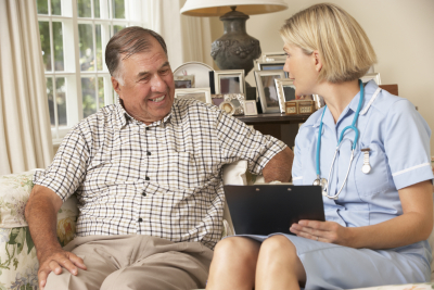 senior man and beautiful nurse smiling