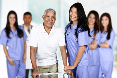 group of medical staff and senior man smiling